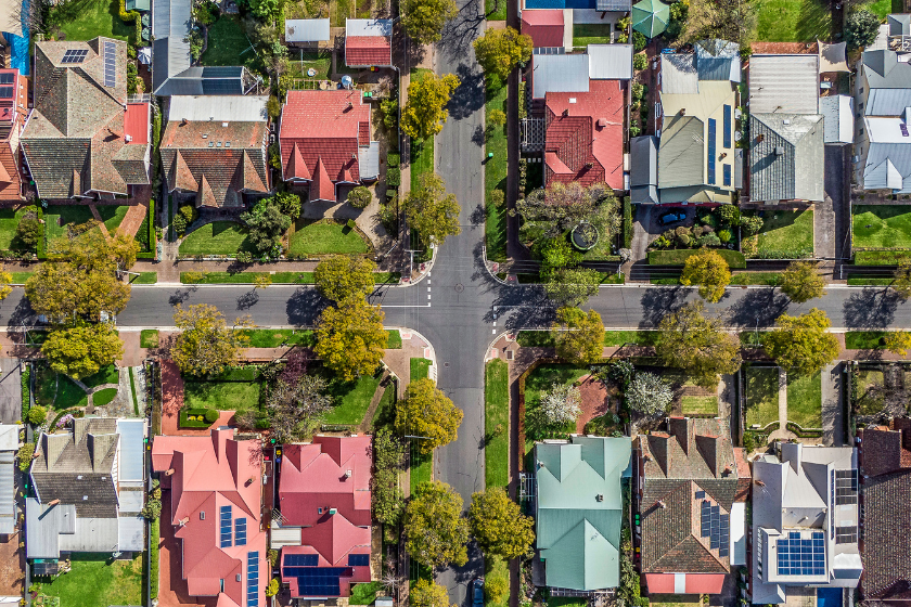 Aerial view of leafy eastern suburban houses on a 4-way cross road intersection