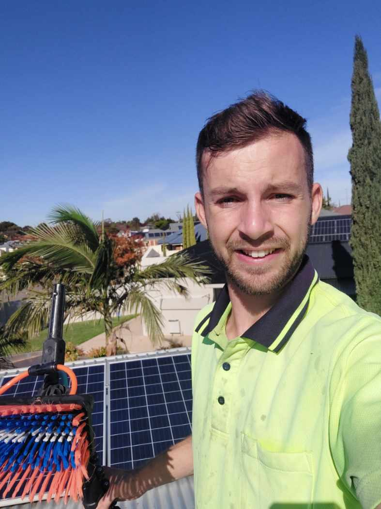 Mike Marrable on top of a roof being fitted with solar panels