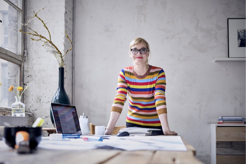 federal-election-GettyImages-72867997 Woman leaning on her desk smiling