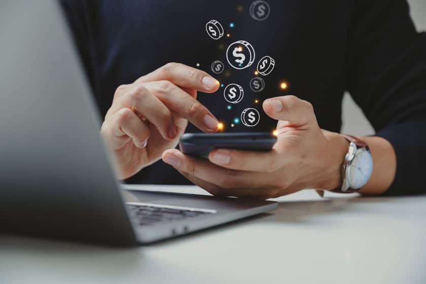 digital coins coming out of phone