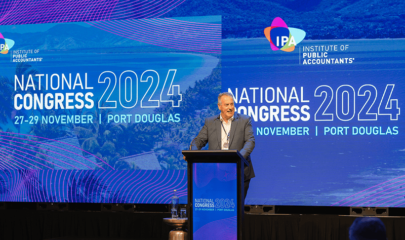 Arthur Athanasiou speaking at a podium