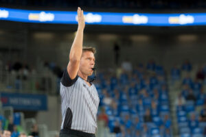 An umpire controls a game of soccer.